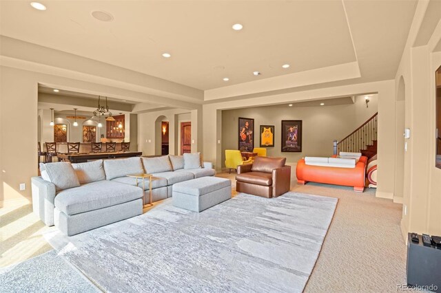 living room with light colored carpet and a raised ceiling