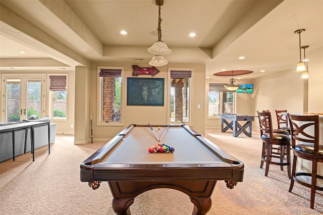 rec room featuring pool table, light colored carpet, and a tray ceiling