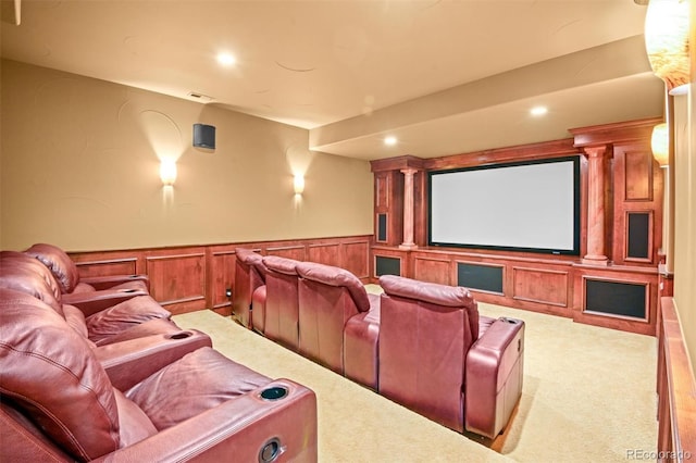 home theater room with decorative columns and light carpet