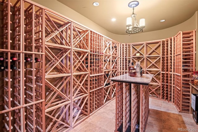 wine room with a chandelier and tile patterned flooring