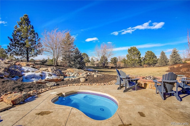 view of swimming pool with a patio and a hot tub