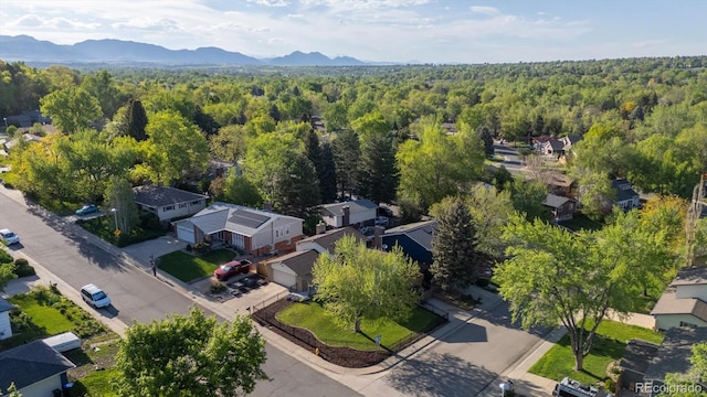 10909 W 65th Way, Arvada, CO 80004 - aerial perspective of suburban area with a forest and mountains