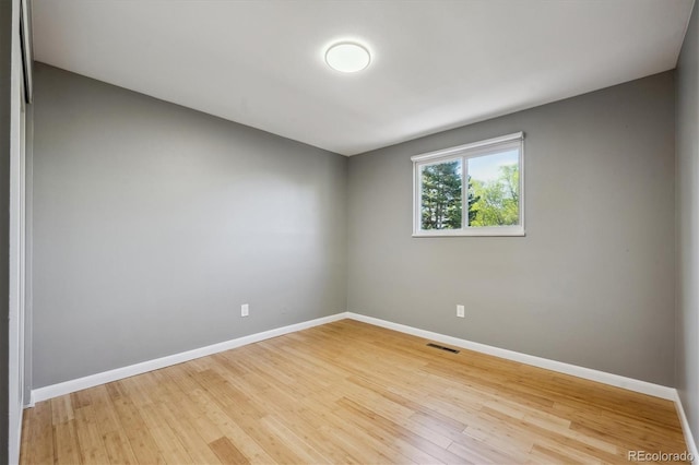 10909 W 65th Way, Arvada, CO 80004 - unfurnished room with baseboards and wood finished floors