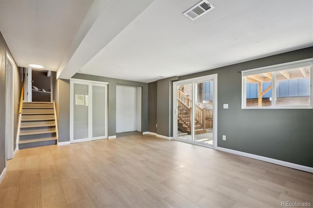 10909 W 65th Way, Arvada, CO 80004 - unfurnished room with stairs, wood finished floors, and baseboards