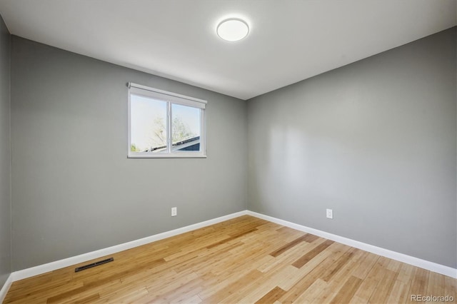10909 W 65th Way, Arvada, CO 80004 - spare room featuring baseboards and wood finished floors
