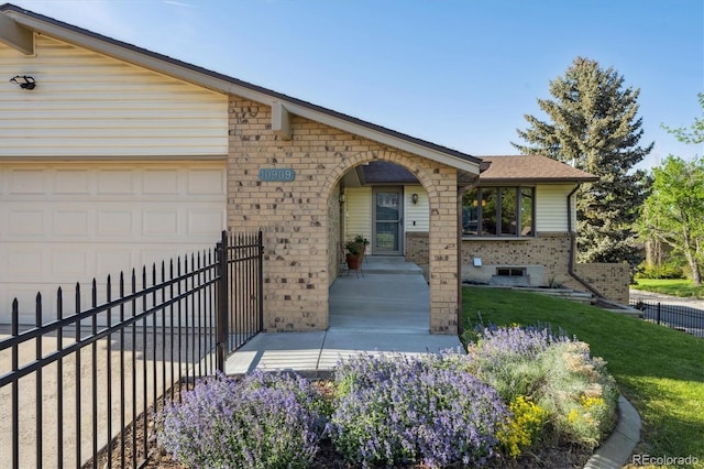 10909 W 65th Way, Arvada, CO 80004 - view of front facade with brick siding and an attached garage