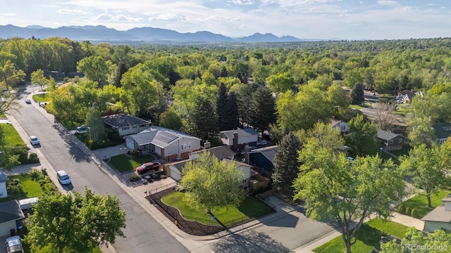 10909 W 65th Way, Arvada, CO 80004 - aerial view of residential area with a heavily wooded area and a mountainous background