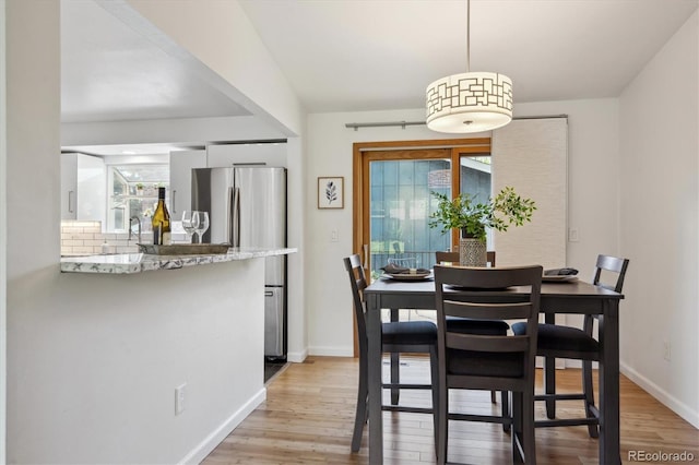 10909 W 65th Way, Arvada, CO 80004 - dining space with plenty of natural light and light wood-style floors