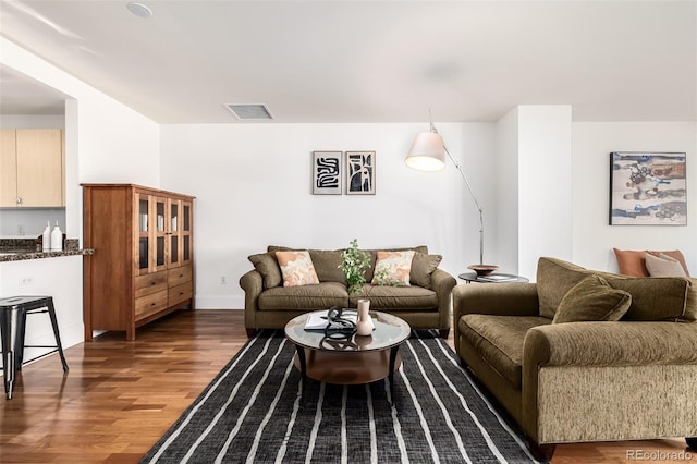 living room featuring dark wood-type flooring