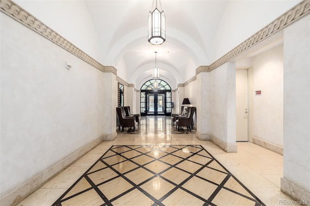 corridor with lofted ceiling and french doors