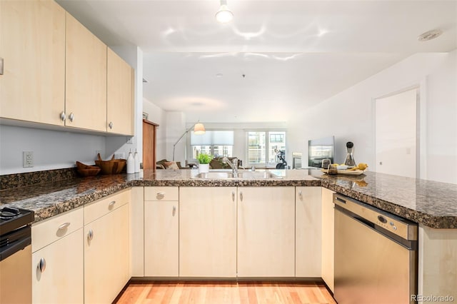 kitchen featuring range, stainless steel dishwasher, light hardwood / wood-style floors, sink, and kitchen peninsula