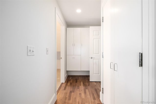 corridor with light hardwood / wood-style flooring