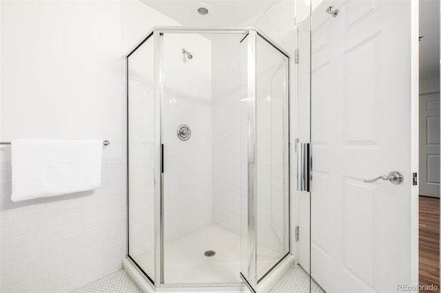 bathroom with a shower with shower door