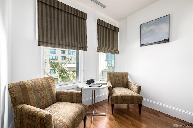 living area with hardwood / wood-style floors