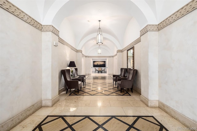 hall featuring vaulted ceiling