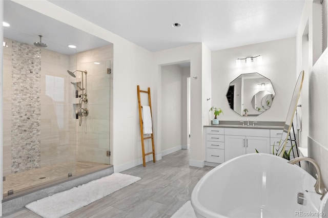 bathroom with independent shower and bath and vanity