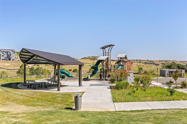 view of community featuring a playground and a lawn