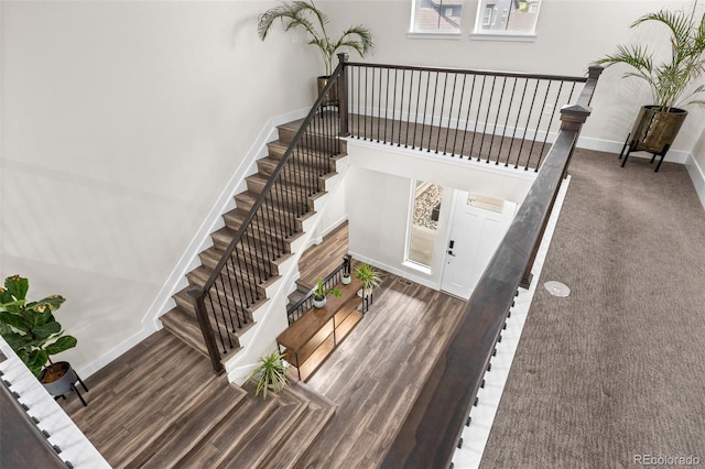 stairway featuring wood-type flooring