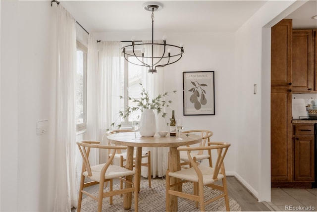 916 Florence St, Aurora, CO 80010 - dining space with a chandelier and light wood-style floors