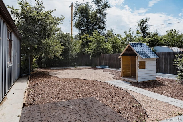 916 Florence St, Aurora, CO 80010 - fenced backyard featuring a patio area and a storage unit