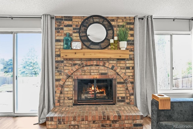 3881 S Bahama St, Aurora, CO 80013 - detailed view of a textured ceiling, wood finished floors, and a brick fireplace