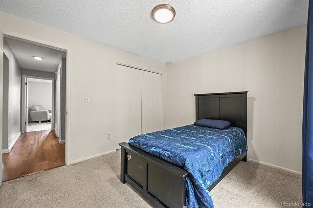 3881 S Bahama St, Aurora, CO 80013 - bedroom with carpet floors, a textured ceiling, a closet, and baseboards