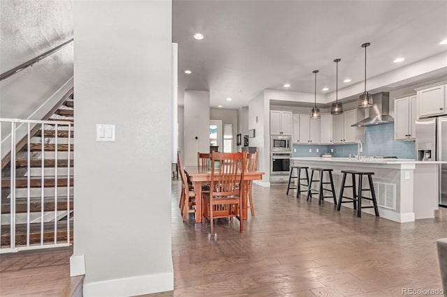 5834 Beeler Ct, Denver, CO 80238 - dining space featuring recessed lighting, stairs, and wood finished floors