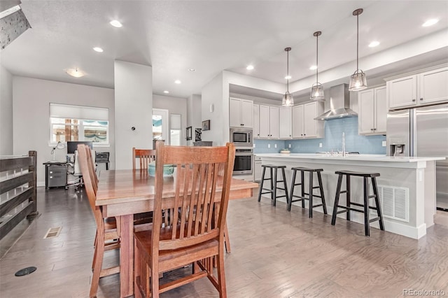 5834 Beeler Ct, Denver, CO 80238 - dining room with light wood-style floors and recessed lighting