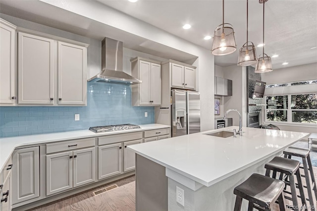 5834 Beeler Ct, Denver, CO 80238 - kitchen featuring wall chimney range hood, appliances with stainless steel finishes, decorative backsplash, light countertops, and recessed lighting