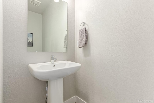 5834 Beeler Ct, Denver, CO 80238 - bathroom with a textured wall and a sink