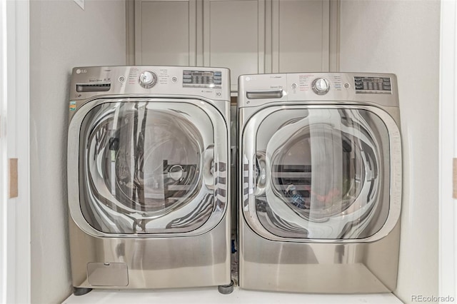 5834 Beeler Ct, Denver, CO 80238 - laundry area featuring washer and clothes dryer and cabinet space