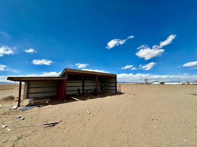 view of stable with a rural view