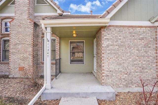 property entrance with brick siding