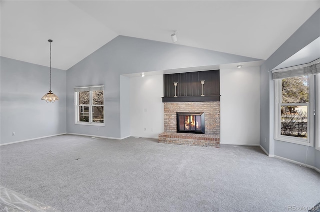 unfurnished living room with high vaulted ceiling, a fireplace, baseboards, and light colored carpet