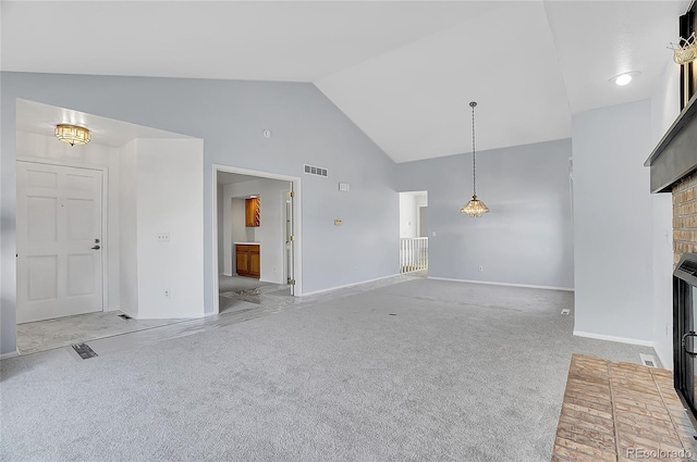 unfurnished living room featuring carpet floors, a brick fireplace, visible vents, and baseboards