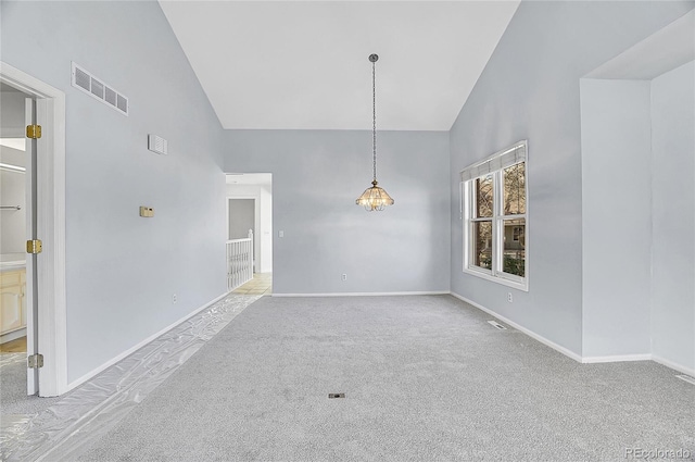 unfurnished dining area with carpet floors, visible vents, high vaulted ceiling, and baseboards