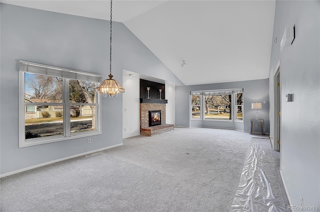 unfurnished living room featuring high vaulted ceiling, a fireplace, carpet flooring, visible vents, and baseboards