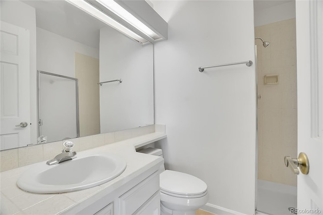 bathroom featuring toilet, walk in shower, and vanity