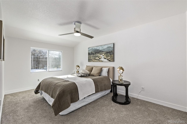 carpeted bedroom with a ceiling fan, a textured ceiling, and baseboards