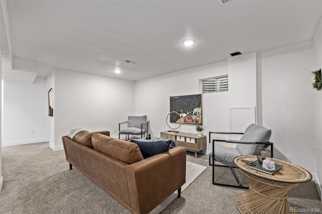 living area with baseboards, recessed lighting, visible vents, and light colored carpet