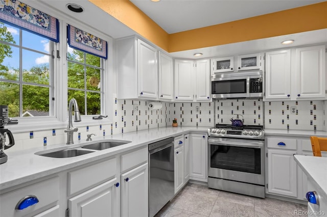 1322 Wicklow St, Boulder, CO 80303 - kitchen featuring stainless steel appliances, a sink, light countertops, and white cabinets