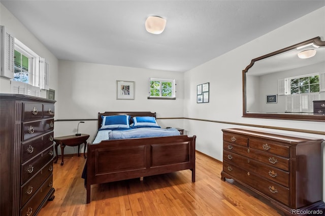 1322 Wicklow St, Boulder, CO 80303 - bedroom featuring light wood-style floors, multiple windows, and baseboards