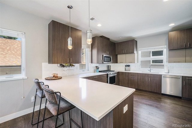 2726 Federal Blvd Unit 1, Denver, CO 80211 - kitchen featuring stainless steel appliances, light countertops, healthy amount of natural light, tasteful backsplash, and recessed lighting