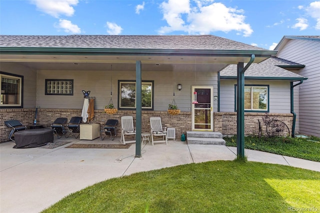 rear view of property featuring a patio area and a yard