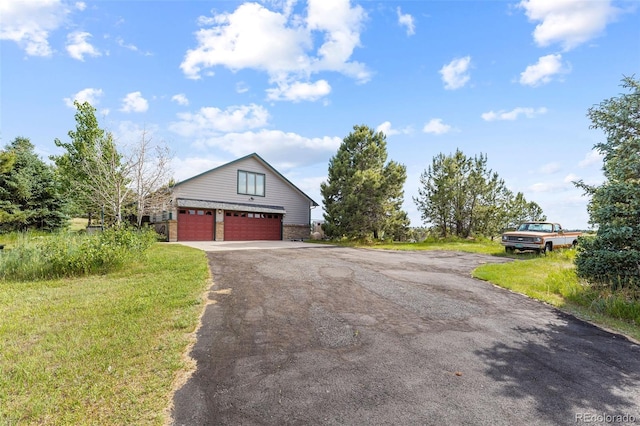 view of side of home featuring a lawn and a garage