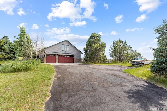 view of front of house with driveway and a front lawn