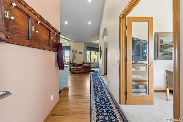hall with vaulted ceiling, recessed lighting, light wood-style flooring, and baseboards