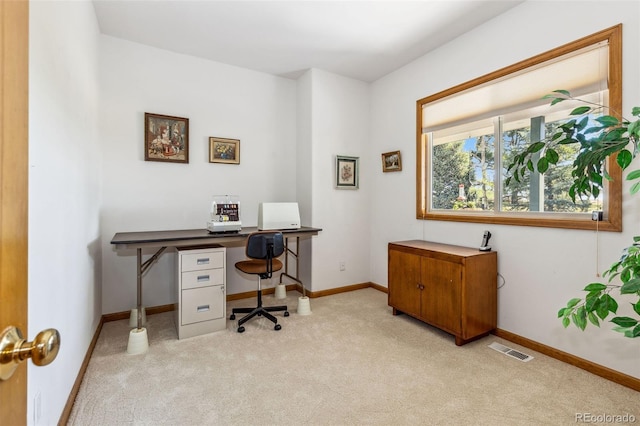 office area featuring baseboards, visible vents, and light colored carpet