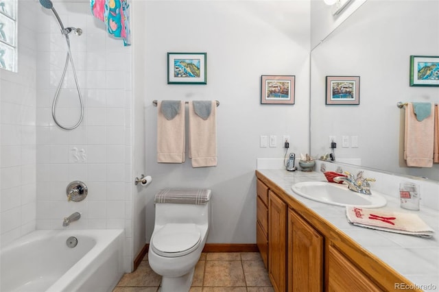 bathroom with bathing tub / shower combination, toilet, vanity, baseboards, and tile patterned floors