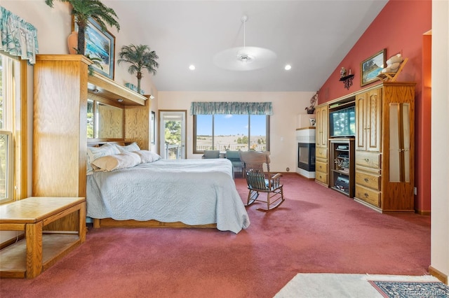 carpeted bedroom with baseboards, high vaulted ceiling, a glass covered fireplace, and recessed lighting